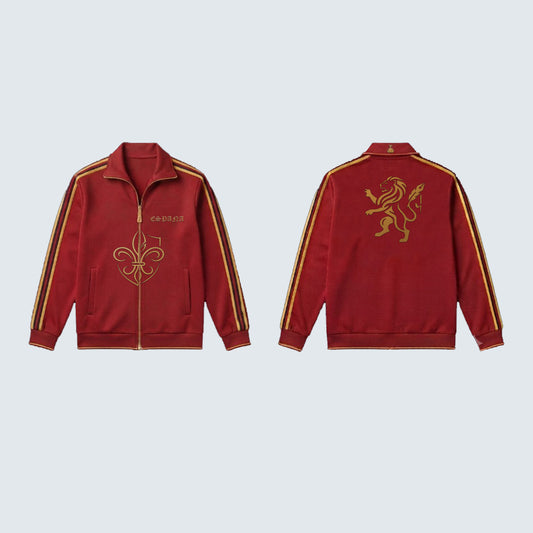 A red zip-up track jacket shown from both front and back views against a light gray background. The jacket features gold embroidered details, including a fleur-de-lis on the front, a lion emblem on the back, and gold stripes down the sleeves.